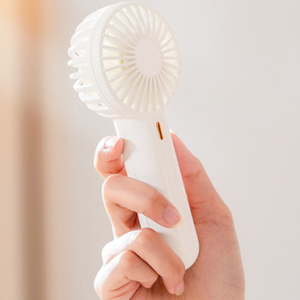 Portable handheld fan for summer cooling.